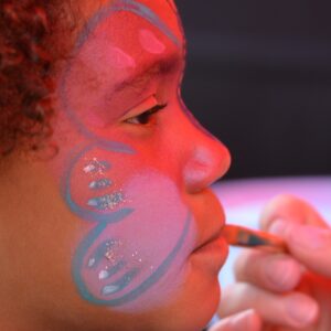 Child getting her face painted.