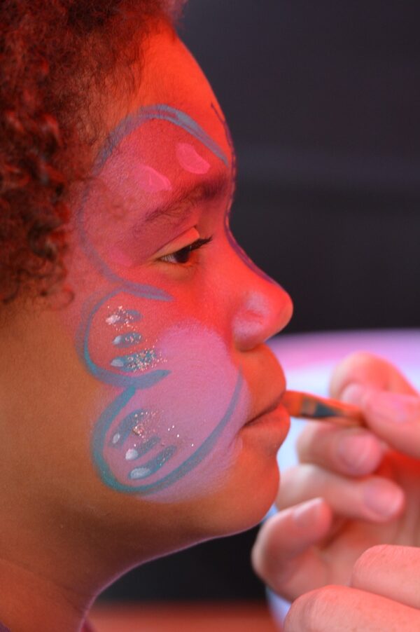 Child getting her face painted.